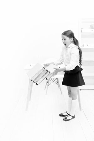 only not this. back to school. shouting girl with workbook folders. Education. heavy documents. Towards knowledge. small girl in school uniform. lot of homework. information. kid learn and study hardの写真素材