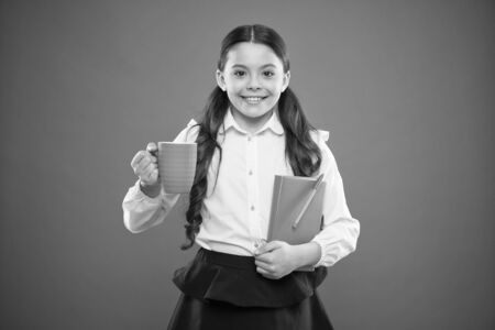 Calories fuel for brain. Girl drink cocoa or tea. Schoolgirl with mug having tea break. Relax and recharge. Water balance. Enjoying tea before school classes. Drink enough water. Inspiring drinkの写真素材