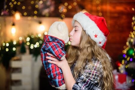 Surprise. Happy new year. Christmas time. Shopping sale. Santa claus little girl. Christmas shopping. Elf child. Xmas tree. Holiday shopping. Little girl in red hat. Shopping day. Love kissの写真素材