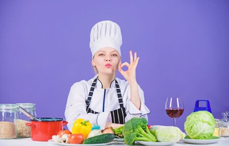 Girl adorable chef teach culinary. Best culinary recipes to try at home. Perfect recipe. Turn ingredients into delicious meal. Culinary skills. Woman chef wear hat apron near table ingredientsの写真素材