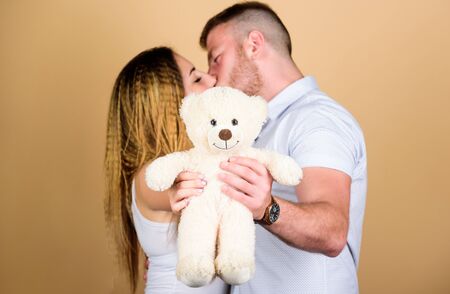 Soft toy teddy bear gift. Pregnancy concept. Man and woman couple in love. Future parents. Family love. Man and pretty girl in love. Guy and girl cuddling. Happy family. Valentines day holidayの写真素材