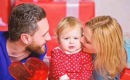 Something is going to surprise her. father, mother and doughter child. Happy family with present...