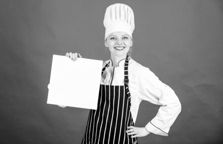 woman in cook hat and apron. professional chef in kitchen. Cuisine. restaurant menu. Culinary dieting. happy woman cooking healthy food by recipe. Housewife with cookery book. healthy organic foodの写真素材