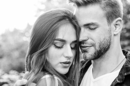 Man hipster and pretty woman in love. Summer vacation. Fall in love. Pure feelings. Enjoying intimacy. Romantic date concept. Beautiful people. Happy together. Couple in love. Cuddling with darlingの写真素材