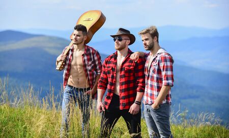 Adventurers squad. Long route. Tourists hiking concept. Hiking with friends. Men with guitar hiking...