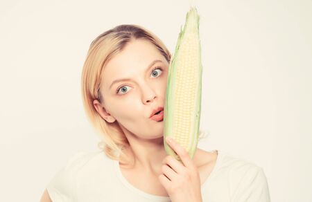 Vegetarian menu. Eat corn benefits. Healthy food concept. Woman hold yellow corn cob white...