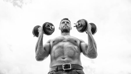 Sportsman with strong torso. Sport equipment. Fitness and bodybuilding sport. Sport lifestyle. Success is choice. Winning is habit. Dumbbell exercise gym. Muscular man exercising with dumbbellの写真素材