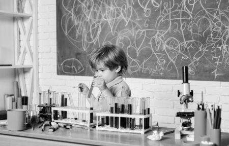 Practical knowledge concept. Study grants and scholarship. Smart children performing chemistry test. Wunderkind and early development. Small pupil learning chemistry in school. Chemistry laboratoryの写真素材