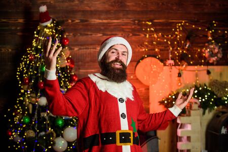 Preparing to Christmas. christmas time. happy new 2020 year. ready for xmas. man with beard at decorated christmas tree. winter holiday. happy bearded santa claus. man in santa hat. feel happinessの写真素材