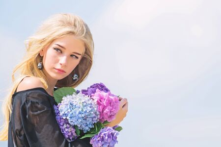 Fashion and beauty industry. Celebrate spring with bouquet. Girl tender fashion model hold hydrangea flowers bouquet. Meet spring with fresh bouquet. Flowers tender fragrance. Bouquet for girlfriendの写真素材