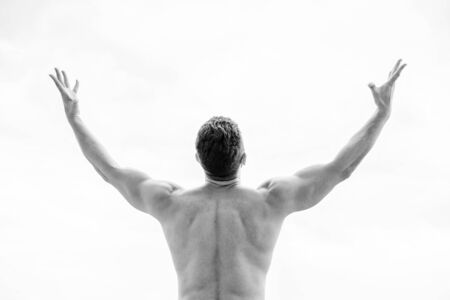 freedom feeling. Get ready to new day. muscular back man isolated on white. Sportsman raising hands. Man cheers success. Healthy lifestyle personal achievement goal and success.の写真素材