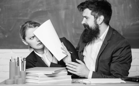 It is unbelievable. businessman and secretary. business couple use laptop and documents. back to school. Non-formal education. teacher and student on exam. paper work. office life. Hard choiceの写真素材