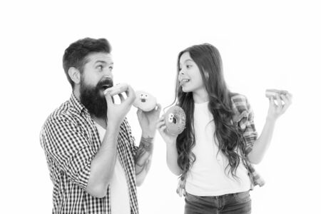 Perfect for dads with sweet tooth. Girl child and dad hold colorful glazed donuts. Sweets and treats concept. Daughter and father eat sweet donuts. Sweet dessert. We love donuts. Fathers day presentの写真素材