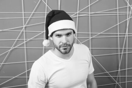 man in santa hat wait for christmas present. online christmas shopping. happy new year. The morning before Xmas. happy santa man. delivery christmas gifts. Christmas composition. Office xmas partyの写真素材