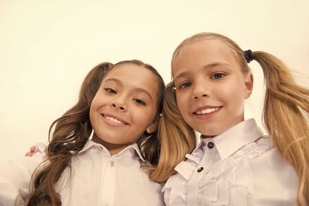 Schoolgirls with cute ponytails hairstyle and brilliant smiles. Best friends excellent pupils. Perfect schoolgirls with tidy appearance. Shine bright. School fashion and style. Take selfie photoの写真素材