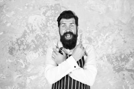 Come and get professional haircut. Barbershop master. Vintage barber. Barber in apron hairdresser equipment blade and scissors. Barber tools. Taking good care facial hair. Bearded hipster shavingの写真素材