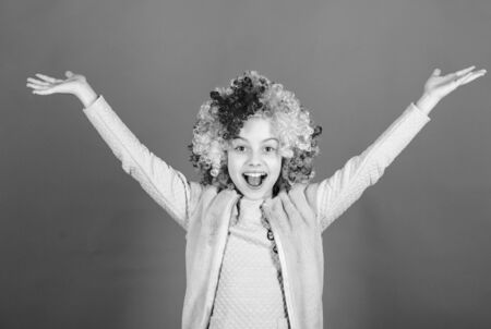 Happiness only real when shared. Happy little girl child wearing bright wig hair smiling with happiness. The child of so much happiness and beauty. Childs happiness and well beingの写真素材
