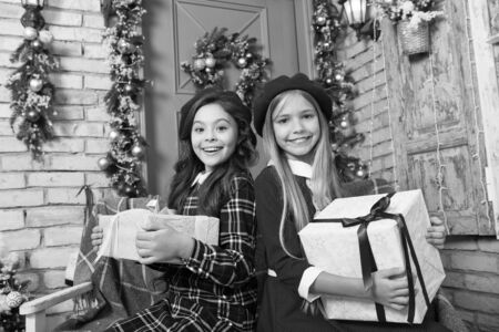 Everything about Christmas is the best. Cute children with New Year presents. Happy little girls...