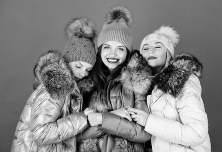 seasonal shopping. happy winter holidays. Friendship. winter clothing fashion. faux fur down jacket. women in padded warm coat. family christmas.の写真素材