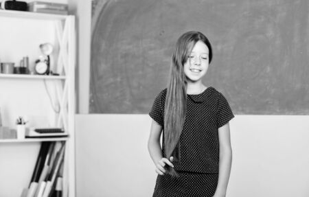 Happy to be graduated. study for future. small girl pupil. happy school girl in classroom. back to school. forms of education. knowledge day is 1st september. childhood happinessの写真素材