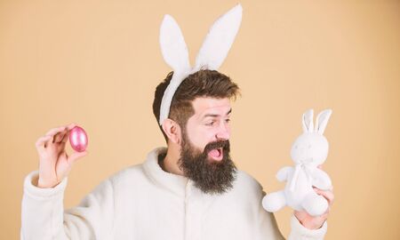 Still childish. Celebrate Easter. Guy bearded hipster cheerful bunny with long white ears. Easter...