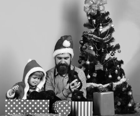 Father and son with happy faces unpack presentsの写真素材