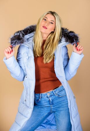 Feeling cozy. woman in padded warm coat. flu and cold. seasonal fashion. happy winter holidays. beauty in winter clothing. cold season shopping. girl in puffed coat. faux fur fashionの写真素材