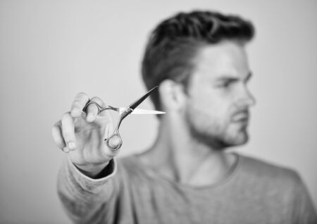 handsome man with scissors. Barbershop concept. getting hairstyle. Barber self care. barber work. Hair care equipment. male grooming. styling beard hair. scissors selective focus. hair cut toolの写真素材