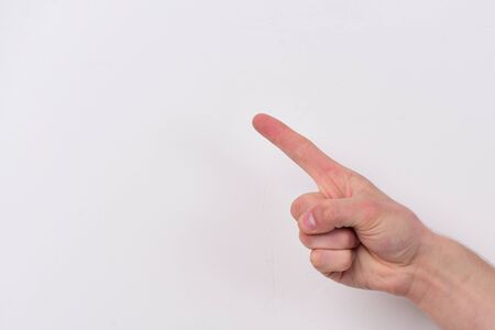 Male hand points up. Hand gesture shows direction. Hand isolated on light grey background, copy...