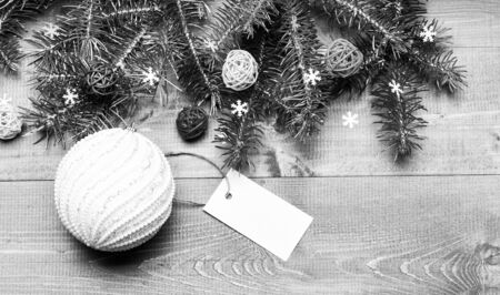 Get ready for christmas. Christmas decorations wooden background top view. Tips for preparing christmas in advance. Winter and christmas holidays concept. Decorative ball toy and gift tag copy space.の写真素材