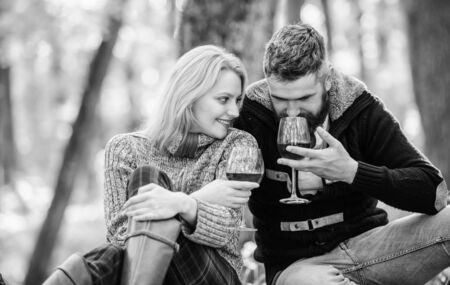 Cheers to friends. love date and romance. Spring mood. happy woman and bearded man drink wine. couple in love relax in autumn forest. camping and hiking. cheers. Family picnic. Valentines dayの写真素材