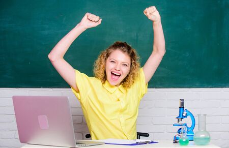 biology experiment. make notes about chemistry research results. happy student with microscope and beaker. scientist teacher at school lab. girl in classroom laboratory with computer. happinessの写真素材