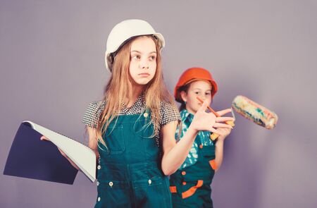 Move in new apartment. Children sisters run renovation their room. Control renovation process. Sisters happy renovating home. Repaint walls. Home improvement activity. Kids girls planning renovationの写真素材