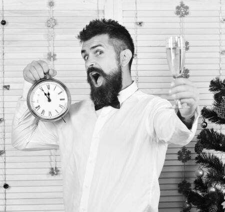 Guy near Christmas tree on wooden wall background
