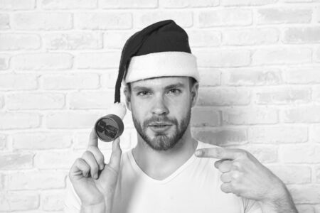 Guy in santa hat point finger at red jewelry boxの写真素材