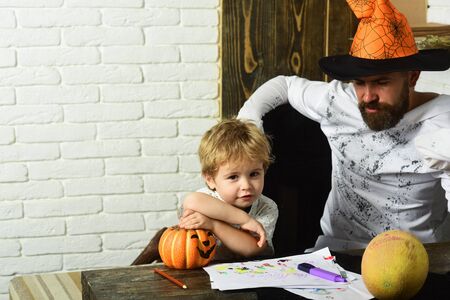 Man in orange hat and kid with interested facesの写真素材