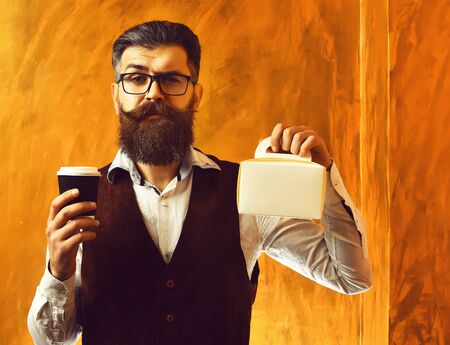 Bearded man, brutal caucasian hipster holding coffee and meal boxの写真素材