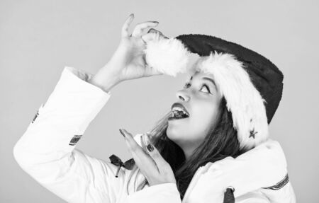 White jacket. Waiting frosty christmas days. Emotional woman makeup face. Santa girl. Girl wear white jacket and santa hat. Jacket has extra insulation to protect your body from sharp winter weatherの写真素材