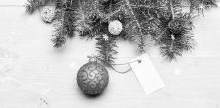 Christmas holidays concept. Decorative ball toy and gift tag copy space. Get ready for christmas. Christmas decorations wooden background top view. Everything you need to decorate christmas treeの写真素材