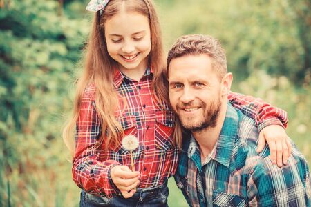 daughter and father with dandelion. little girl and happy man dad. earth day. spring village country. ecology. Happy family day. family summer farm. Help and supportの写真素材