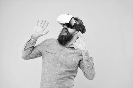 Impressive visual effects. Bearded man explore vr. Gamer concept. Gaming hobby. Cyber sport. Augmented reality. Game development. Digital technology. Living alternative life. Hipster play video gameの写真素材
