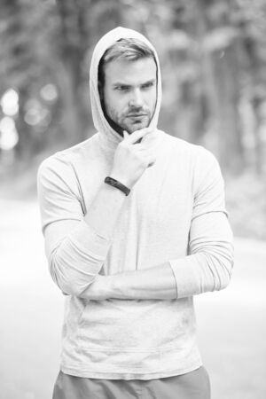 Handsome sport coach. Male beauty. Guy handsome bearded face well groomed bristle. Sportsman lifestyle. Handsome athlete in park. Wellbeing and self care. Handsome man sporty outfit look confidentの写真素材