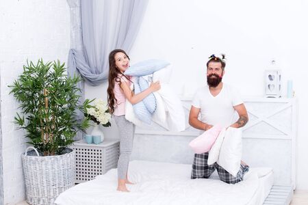 Give affection and support. Sincere emotions. Pajamas party. Happy childhood. Upbringing happy daughter. Happy family. Role of father. Pillow fight. Dad seek live life of integrity and honestyの写真素材
