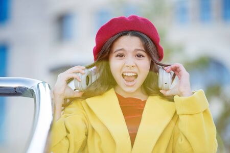 too loud. too high volume level. stresset about amount of information. audio book. listen to music. online education with ebook. e library. little girl shout with headphones. childhood developmentの写真素材