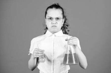 science research in lab. Small school girl. education and knowledge. small girl with testing flask. back to school. child study bilogy lesson. Professional choice. Professional unhappy scientistの写真素材