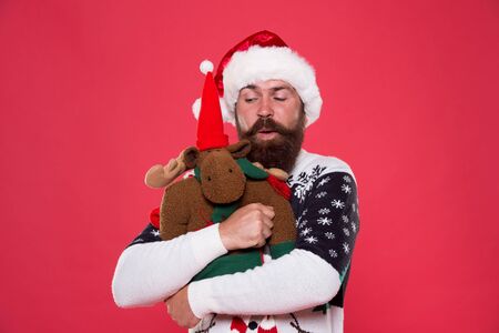 Christmas prep concept. Hipster bearded face winter sweater. Winter holiday. Soft toy. Hug and love....