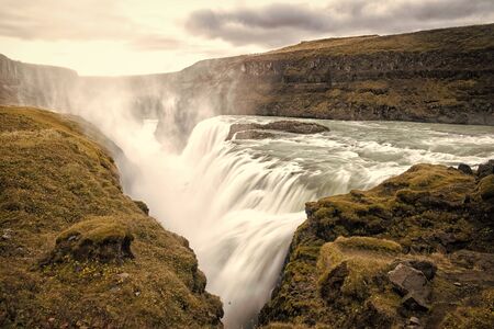 Canyon beauty. Waterfall located in canyon river Iceland. River rapid waterfall. Water beautiful stream flow. Nature landscape. Iceland tourist destinations concept. Waterfall in Iceland. Wet airの写真素材