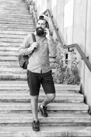 Plan holiday on budget. Travelling spontaneously is great. Slow travel has lot of benefits. Wanderer on tour. Tourist on stairs go sightseeing. Budget travelling tips. Man travelling explore cityの写真素材