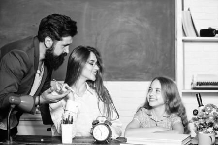 Greatest drawback overprotective parenting style underprepared children. Little girl doing homework. Overprotective family. Overprotective parenting style. Dad mom teaching child. Intelligent familyの写真素材