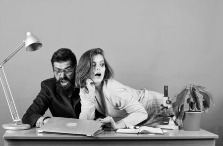 Confidence and charisma. secretary with boss at workplace. woman and man work in office at laptop. businessman and assistant solve problem. business couple at computer. love affair at work. Seductionの写真素材